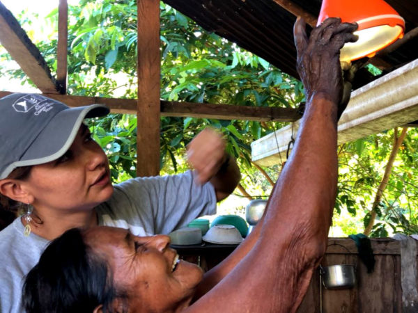 Community member learns how to install and use lamp kits with the assistance of ACT team member