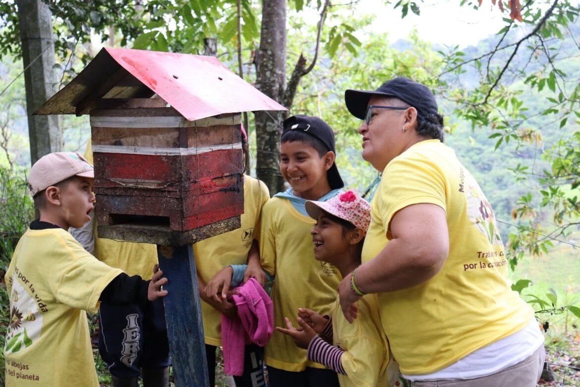Children practicing stingless beekeeping as part of an environmental program