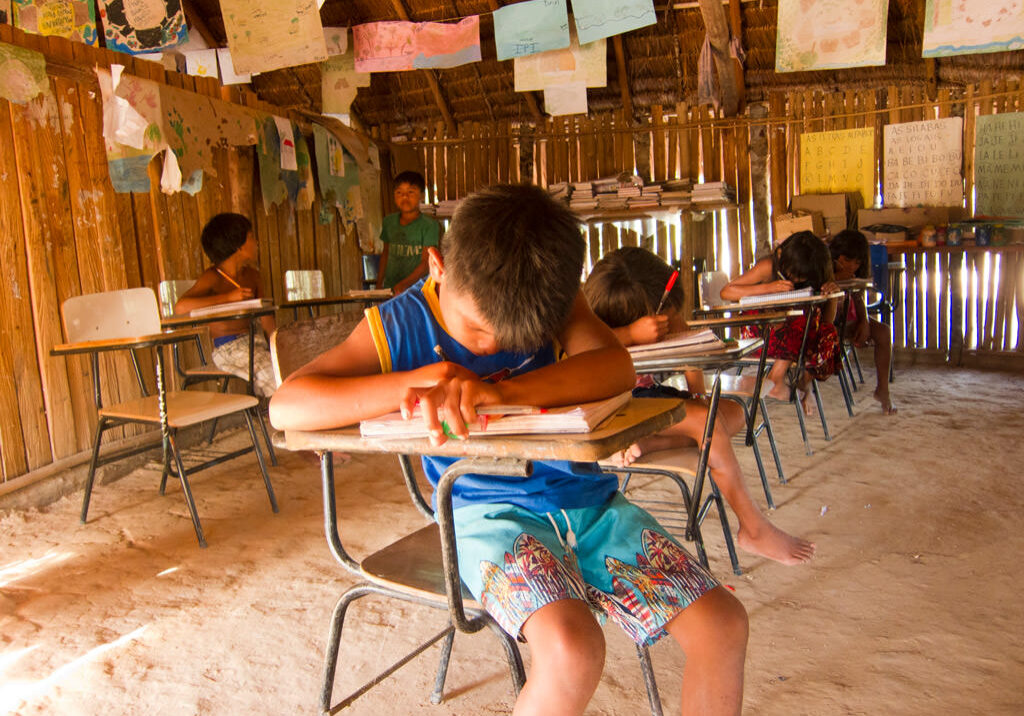 Brazillian child writing on school desk
